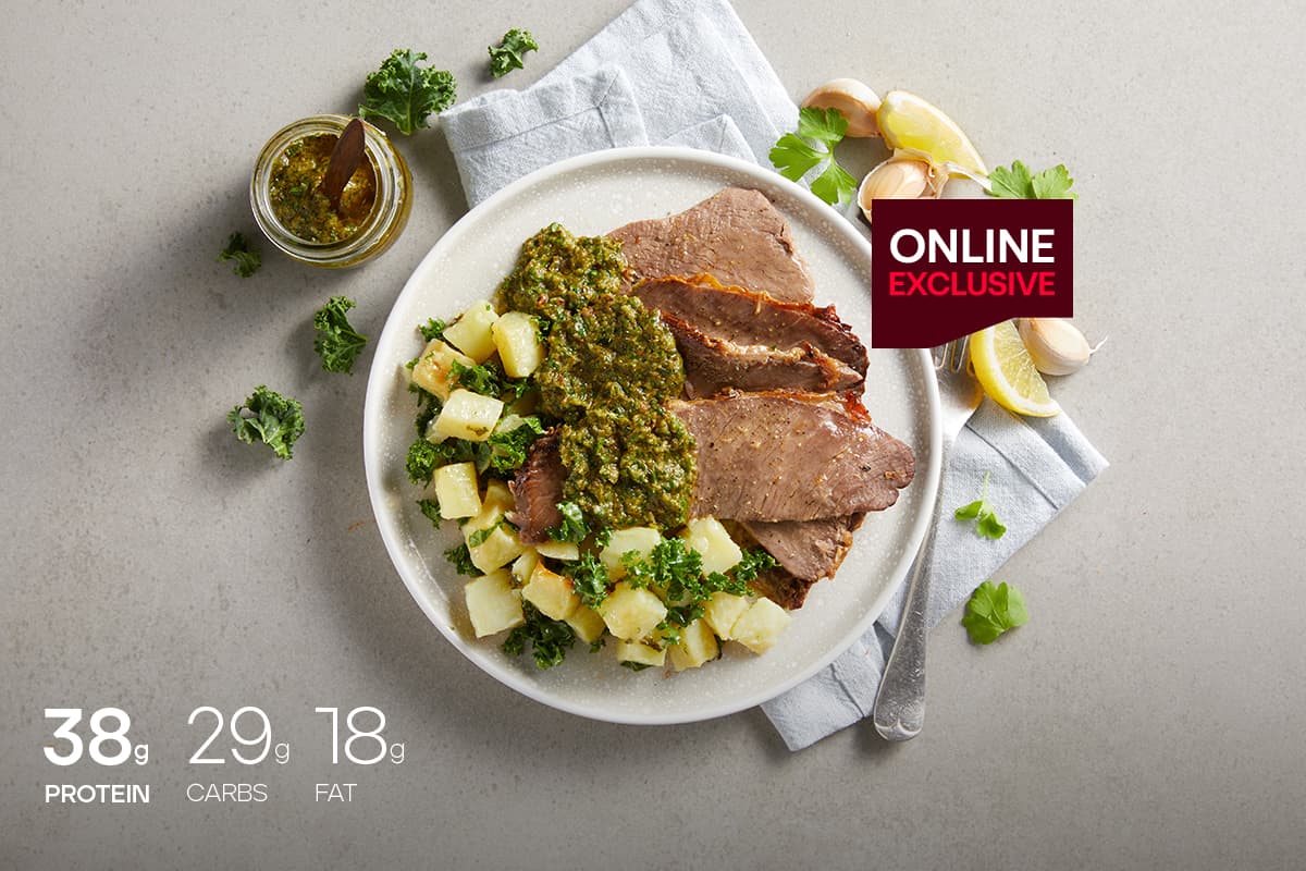 My Muscle Chef Herb Roasted Steak With Potato & Kale Salad plated on a table