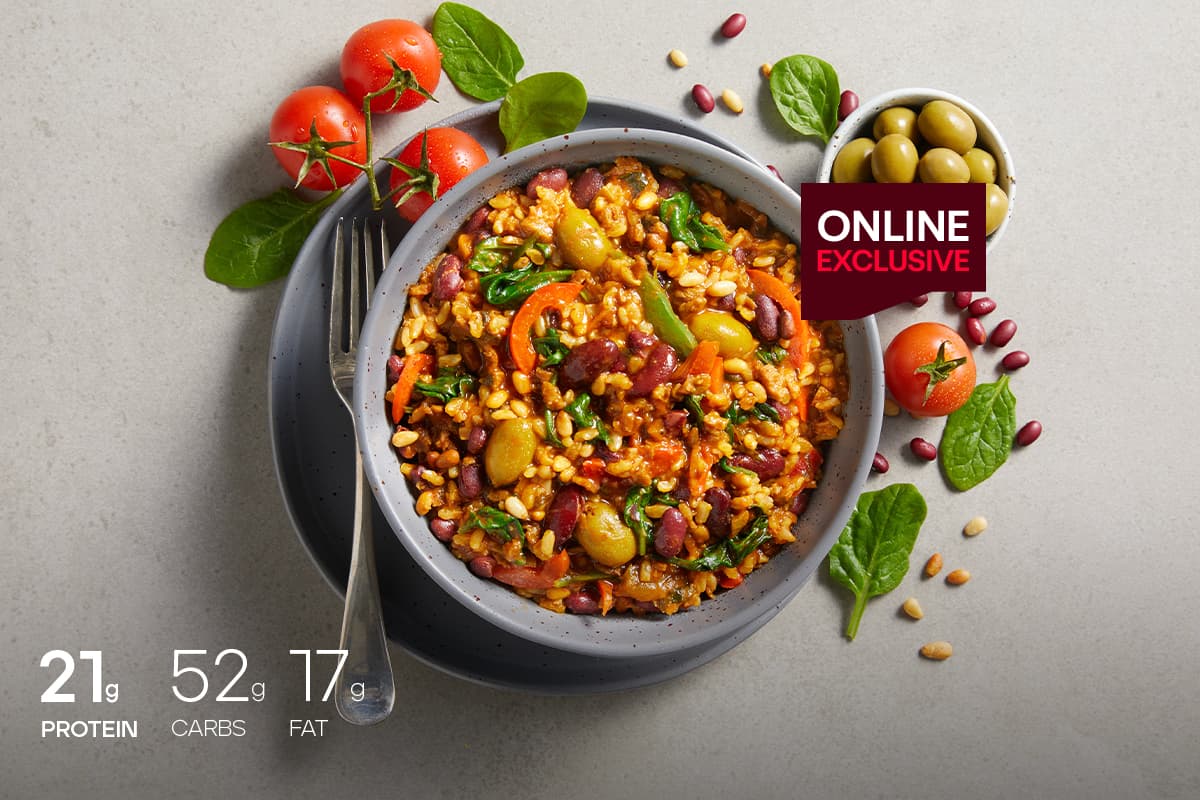 My Muscle Chef Smokey Tomato Rice With Pine Nuts & Olives plated on a table