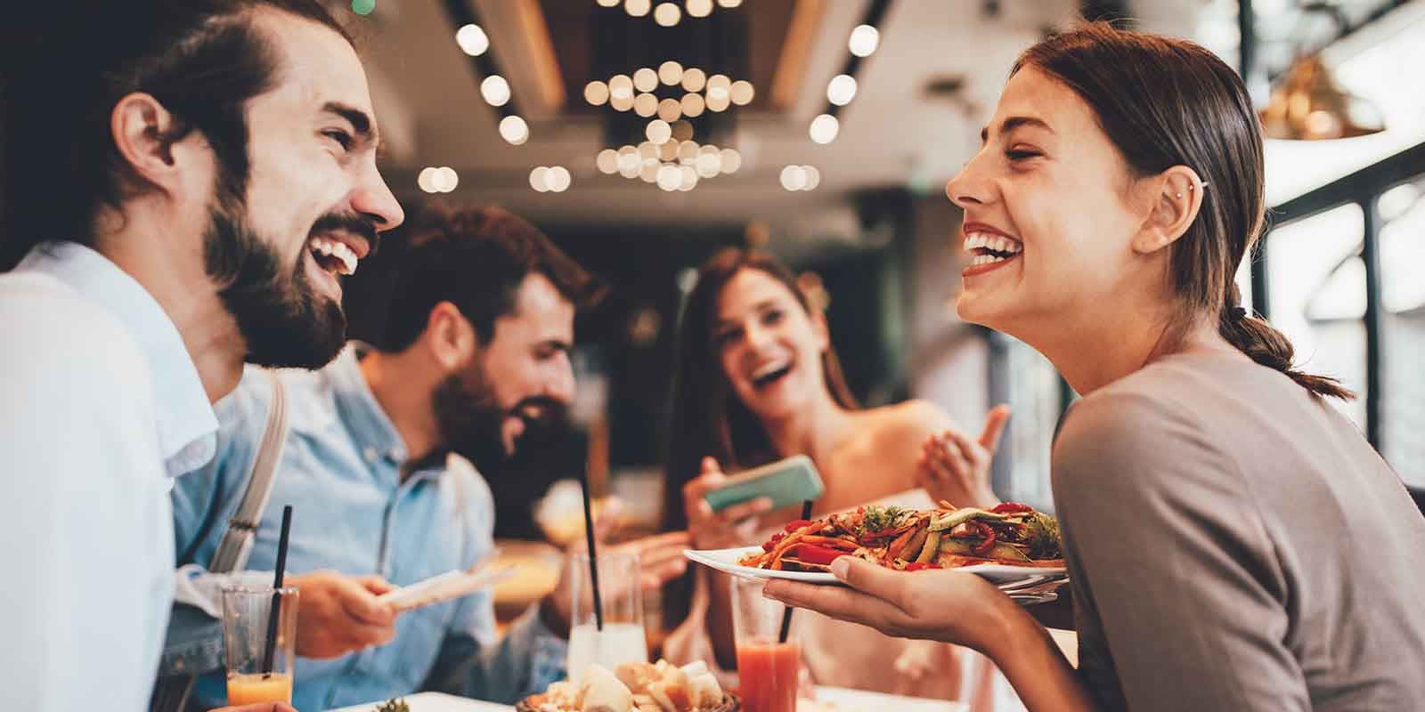 Happy group eating out
