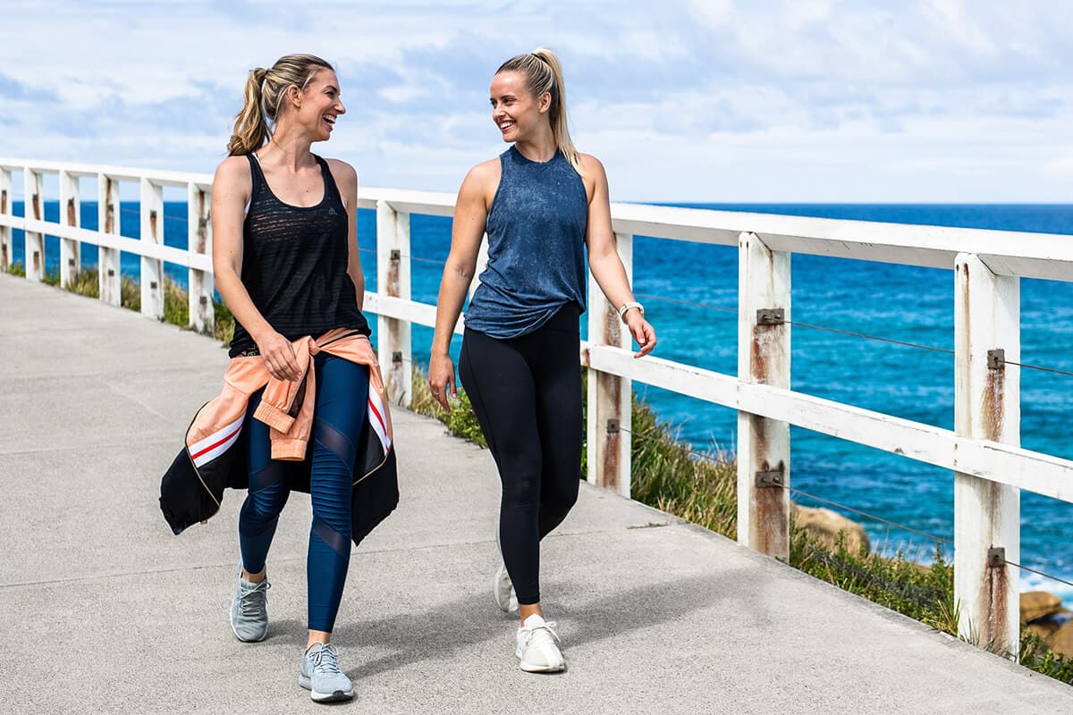 2 females walking along the beach
