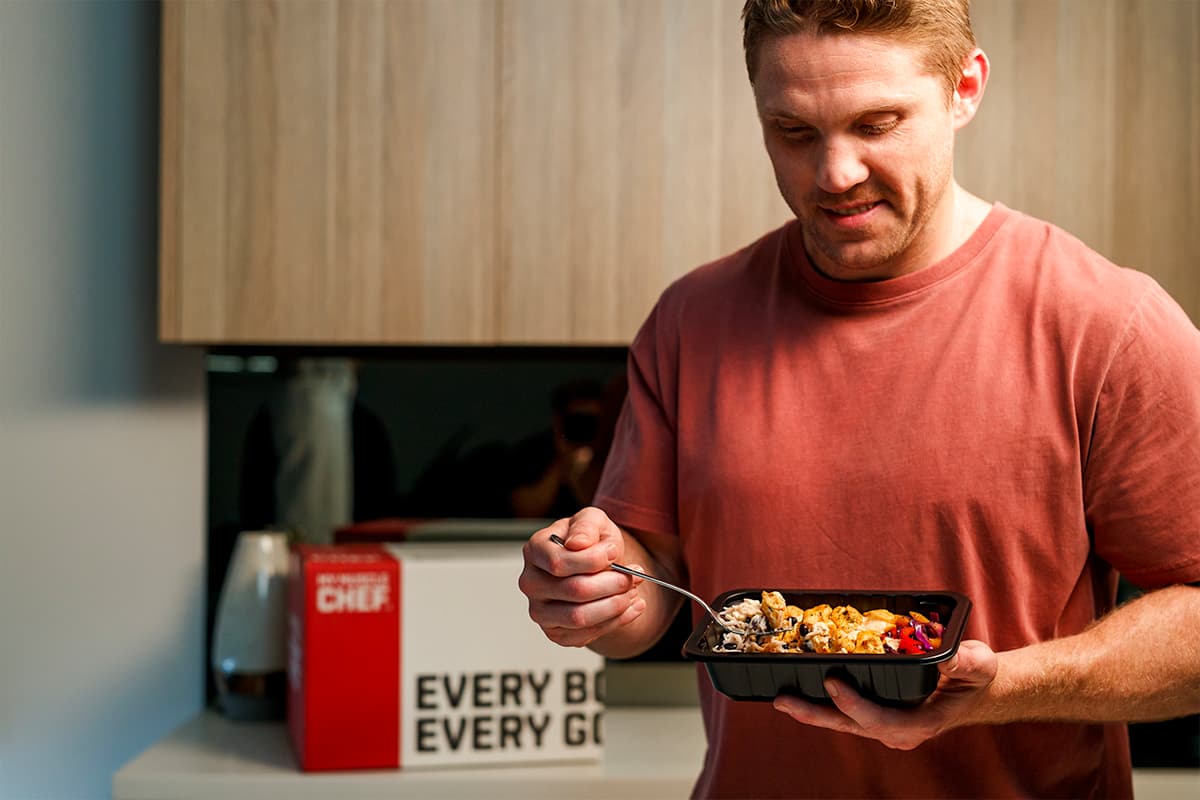 Chris Lawrence eating a my muscle chef meal