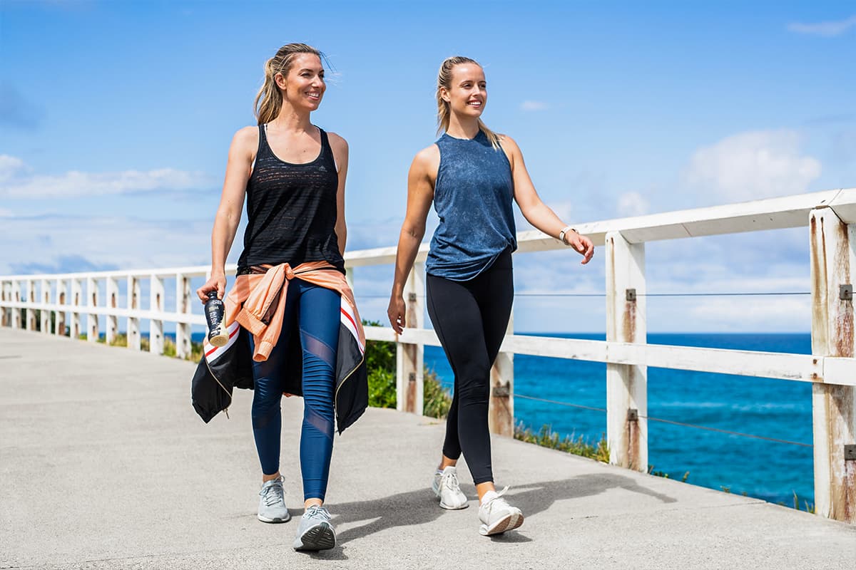 2 females walking along the beach