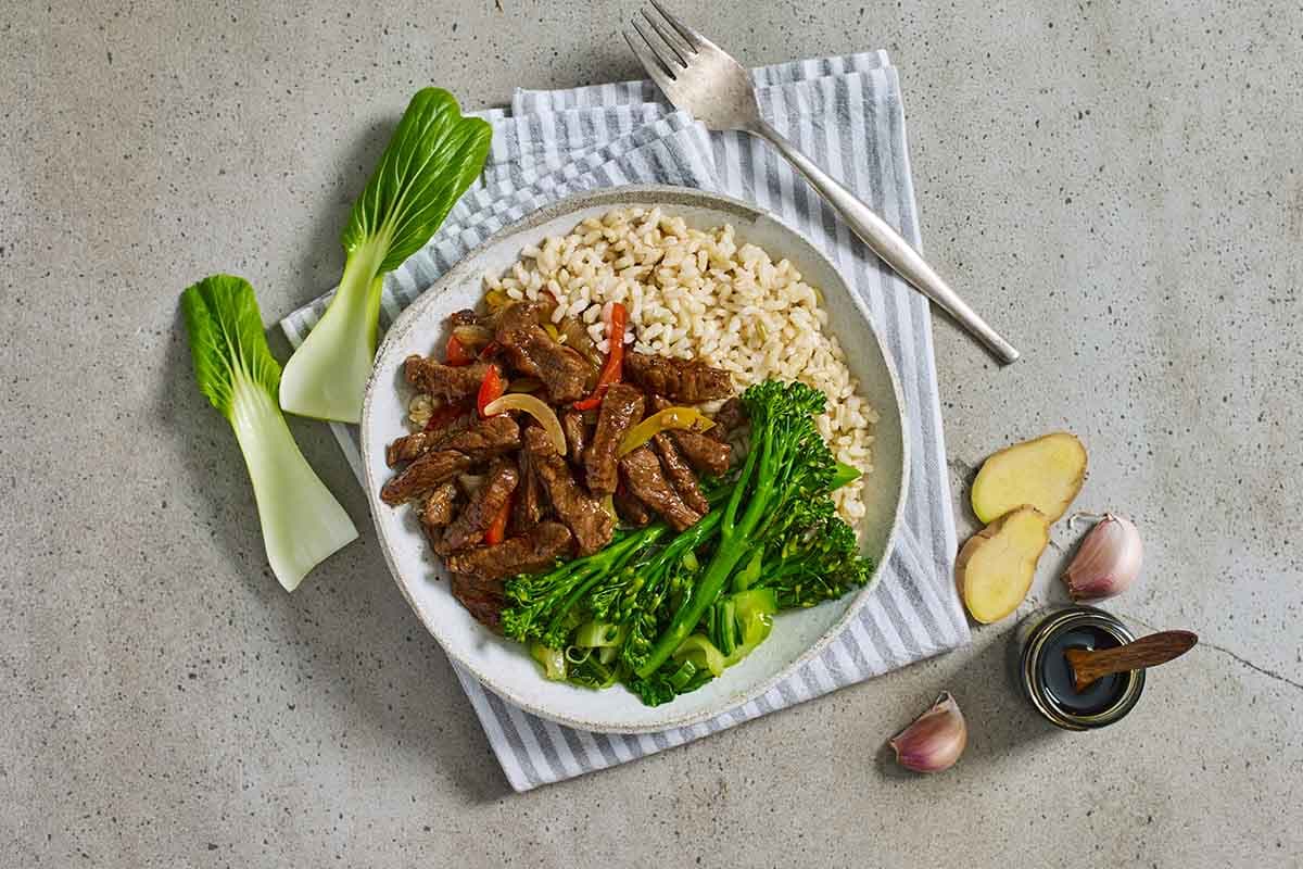 Mongolian beef plated on a table