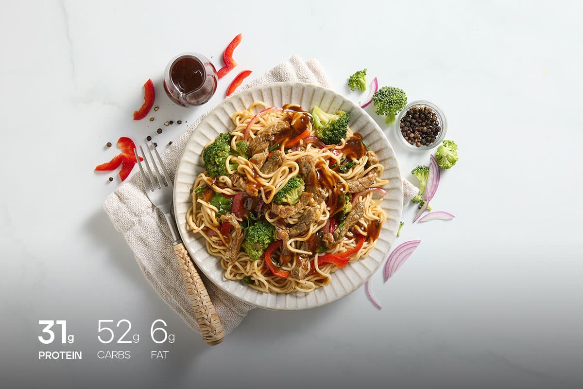 Noodles with beef meal plated on a table