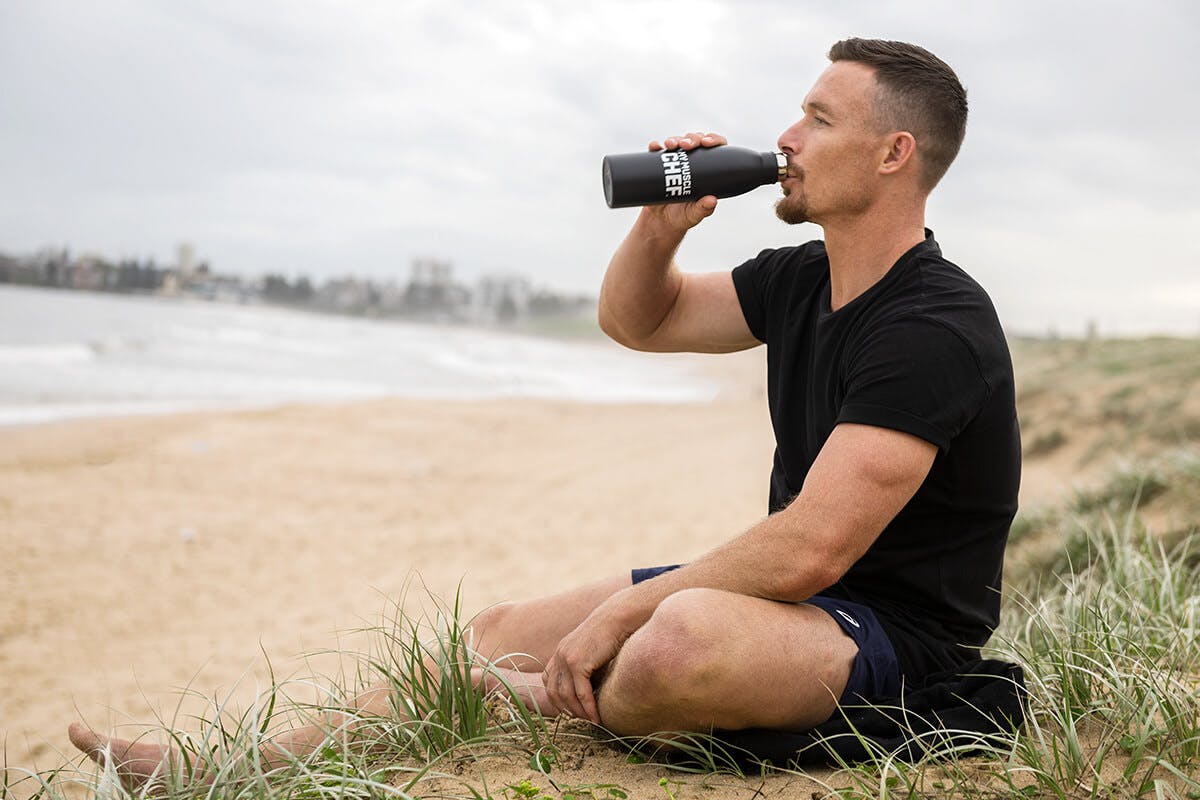 Damien Cook drinking from a my muscle chef water bottle