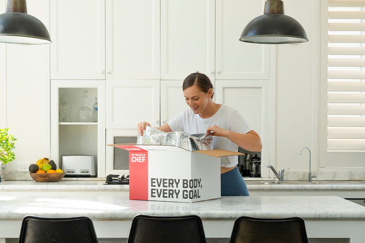 Opening My Muscle Chef delivery box on kitchen bench