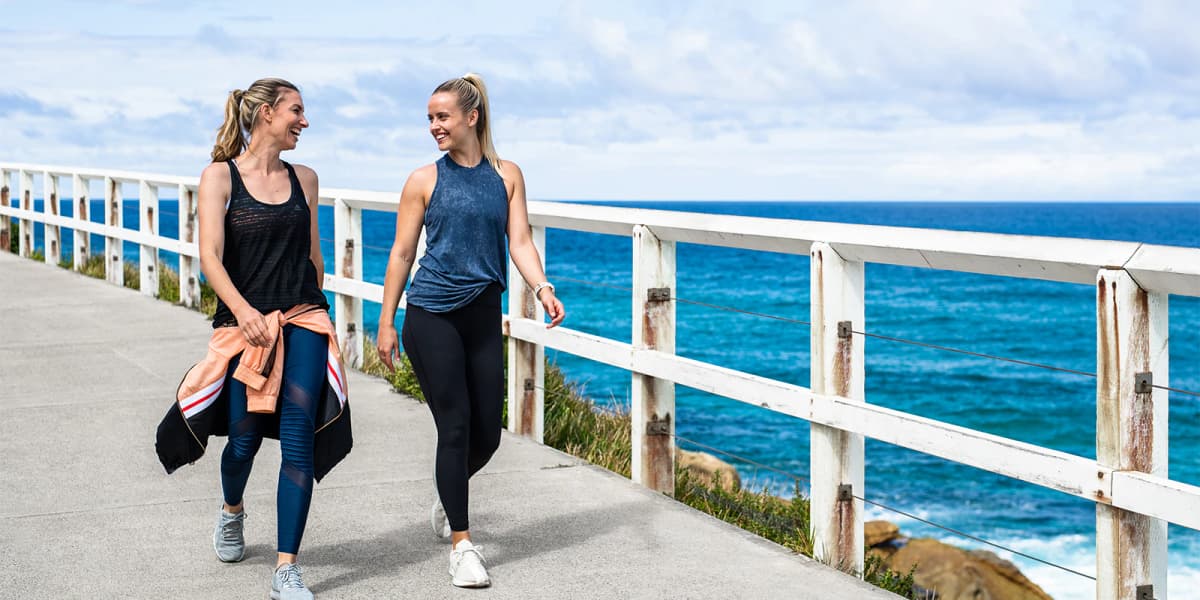 2 females walking along the beach