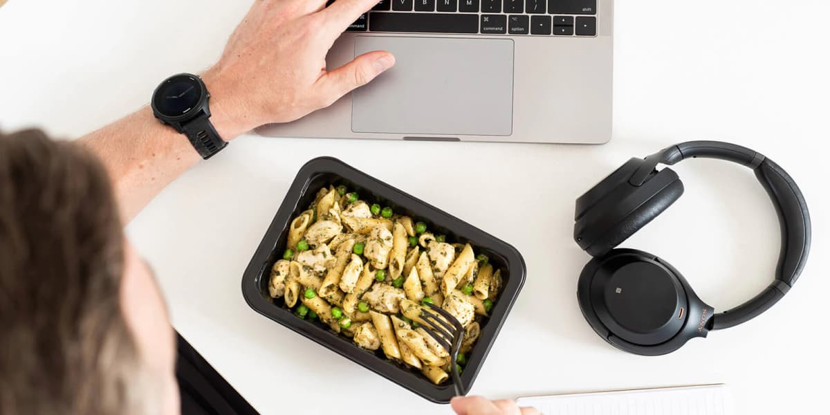 My Muscle chef chicken meal on table with laptop