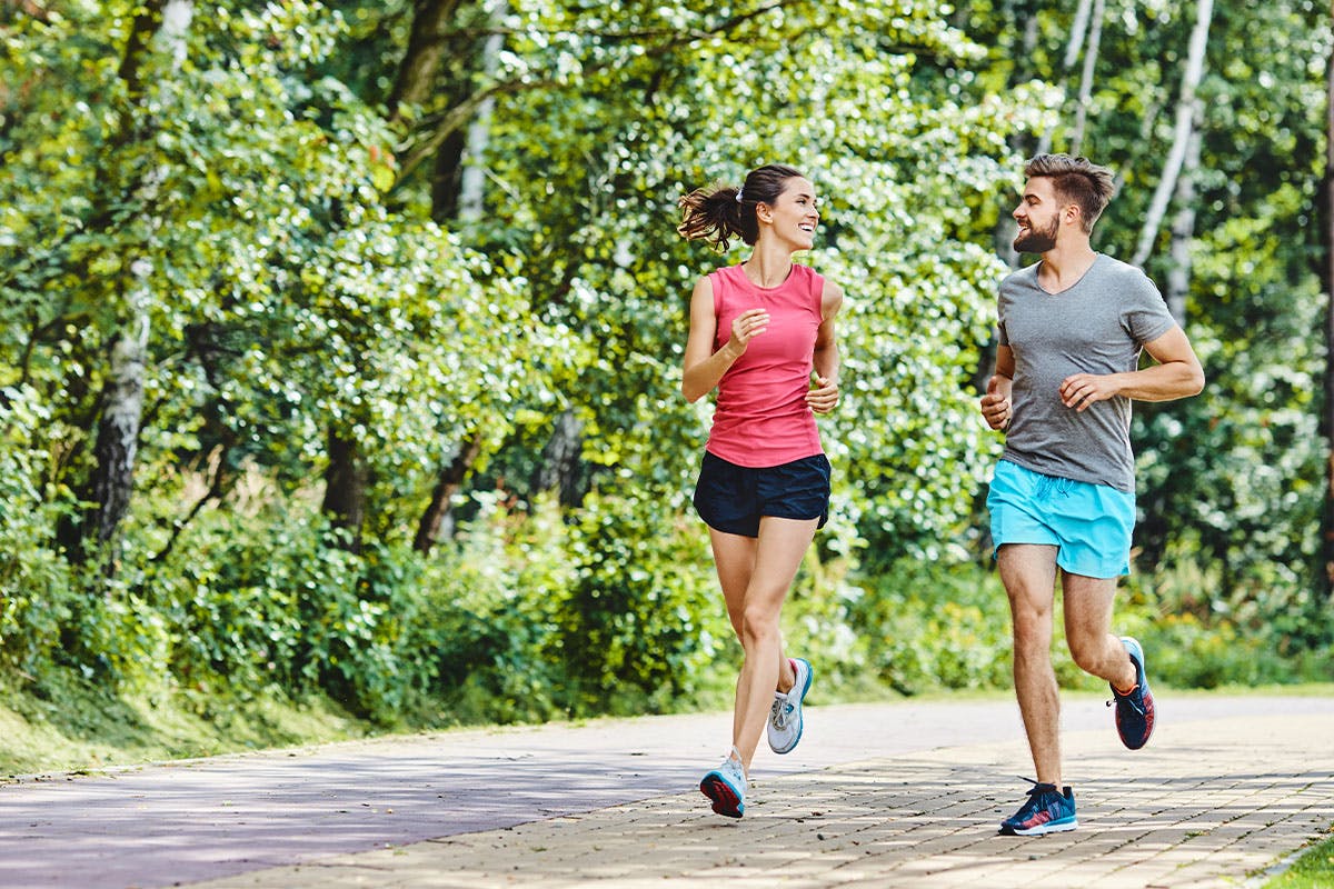 Male and female running in the park