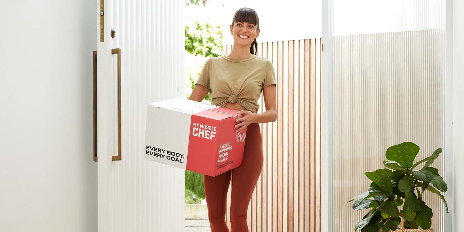 Female holding My Muscle Chef Delivery box