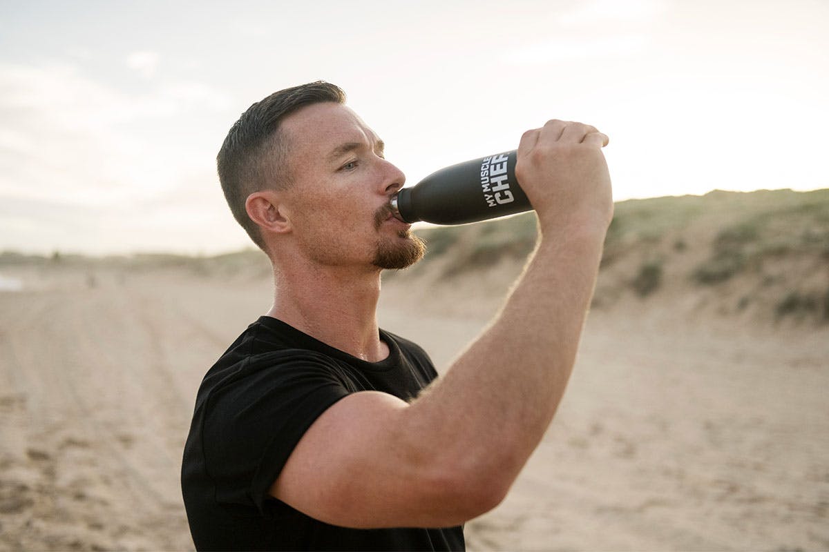 Damien Cook drinking from a My Muscle Chef bottle